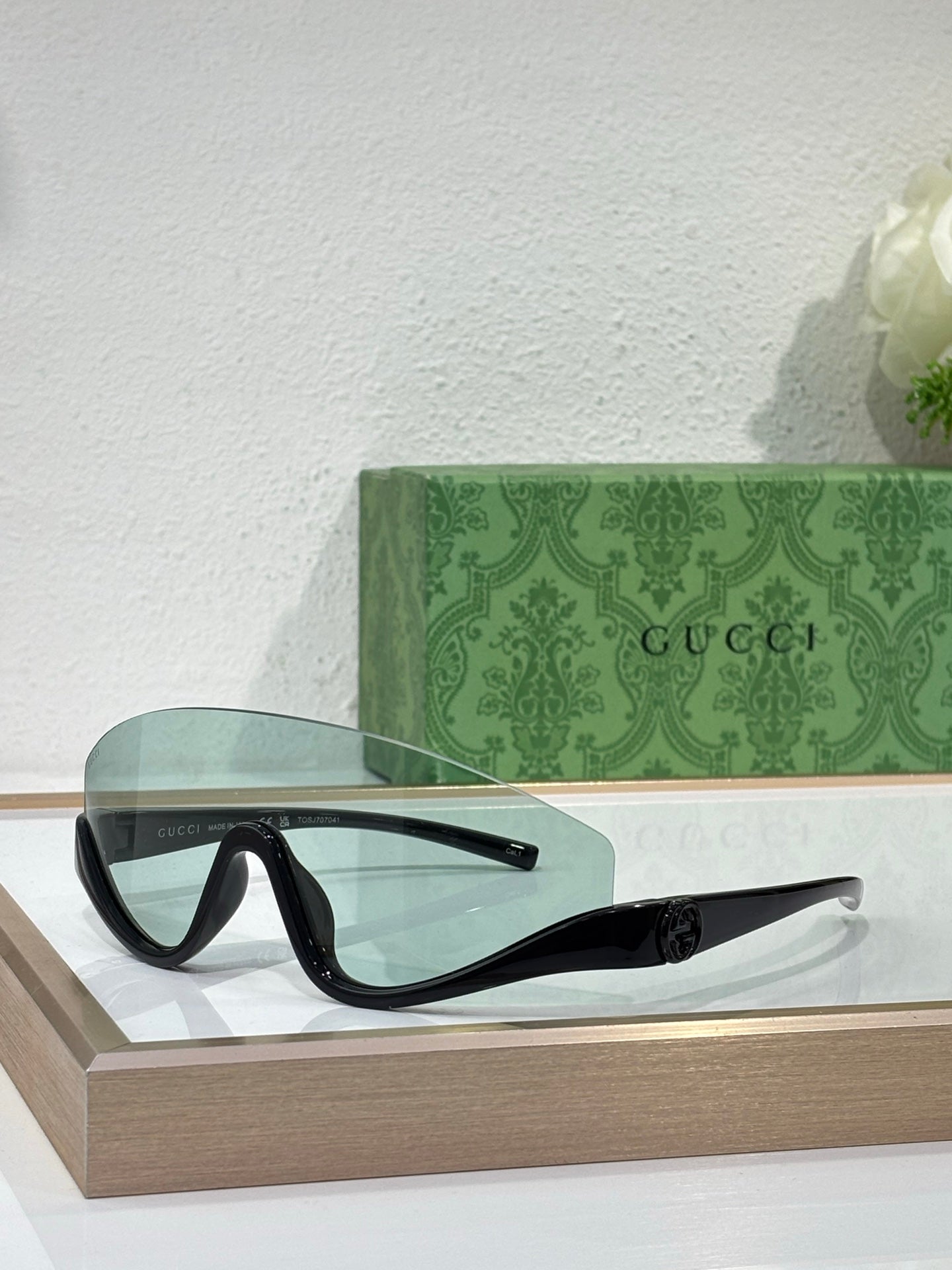 Gucci sunglasses with black frames and dark gradient lenses