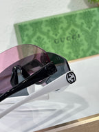 Gucci sunglasses temple close-up with black circular logo detail