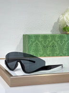 Gucci sunglasses with black oversized frames and dark smoke lenses