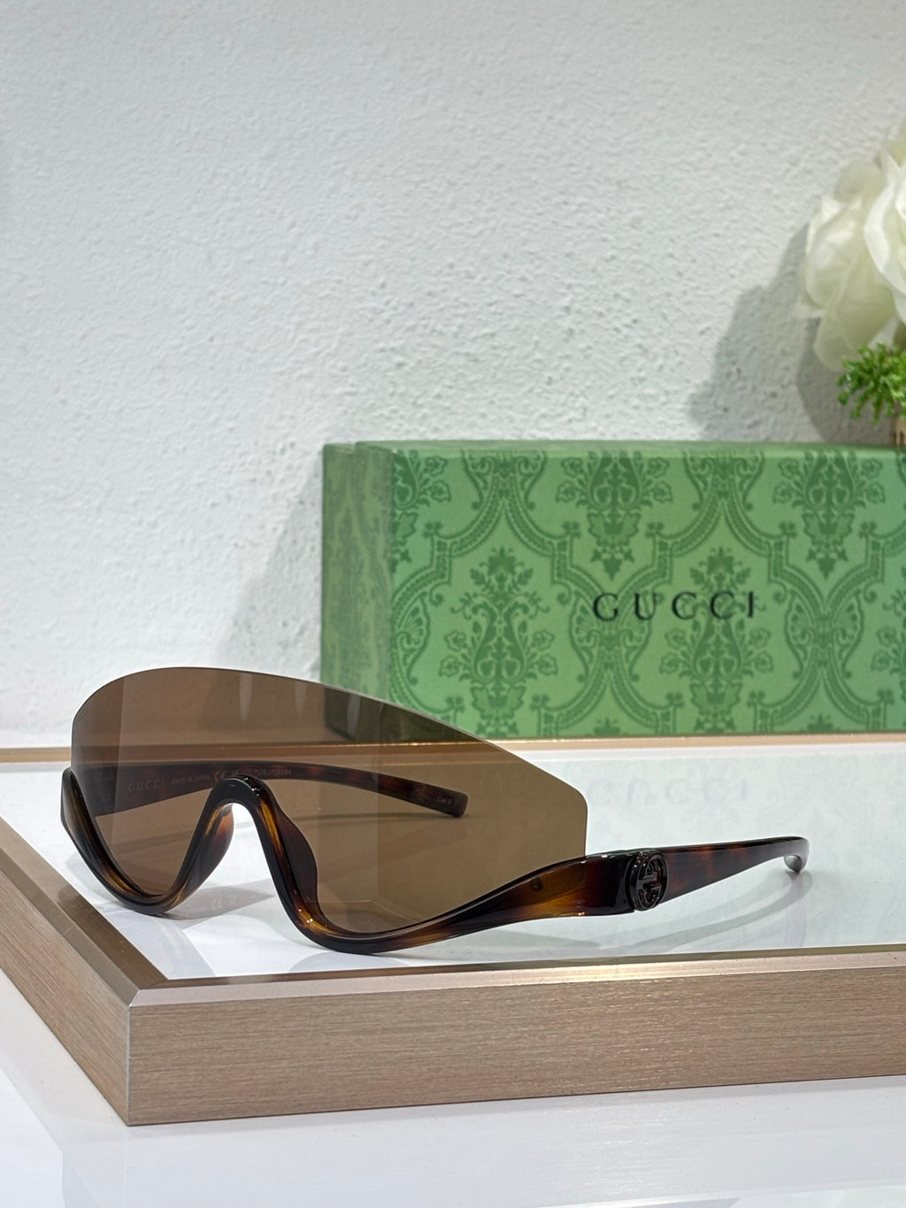 Gucci sunglasses with dark brown frames and gradient lenses