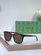 Gucci sunglasses with dark tortoise frames and dark brown tinted lenses