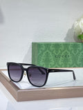 Gucci sunglasses with black frames and dark purple tinted lenses