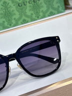 Gucci sunglasses close-up with dark navy frames and purple tinted lenses