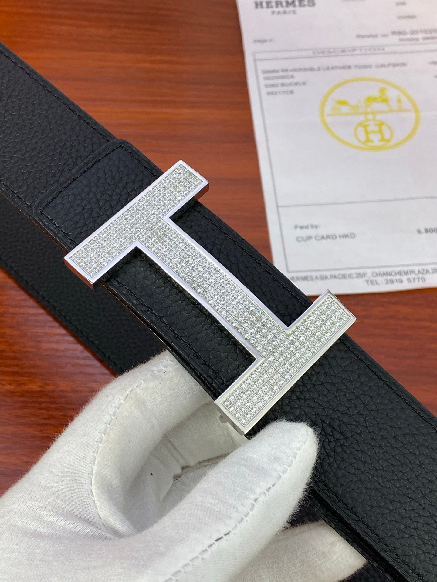 Hermes belt close-up: silver-tone H buckle with rhinestone-style detailing