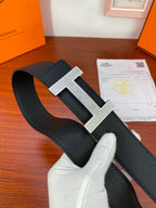 Hermes belt on display with black strap and silver-tone H buckle