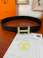 Hermes belt with black textured leather and gold-tone H buckle front view