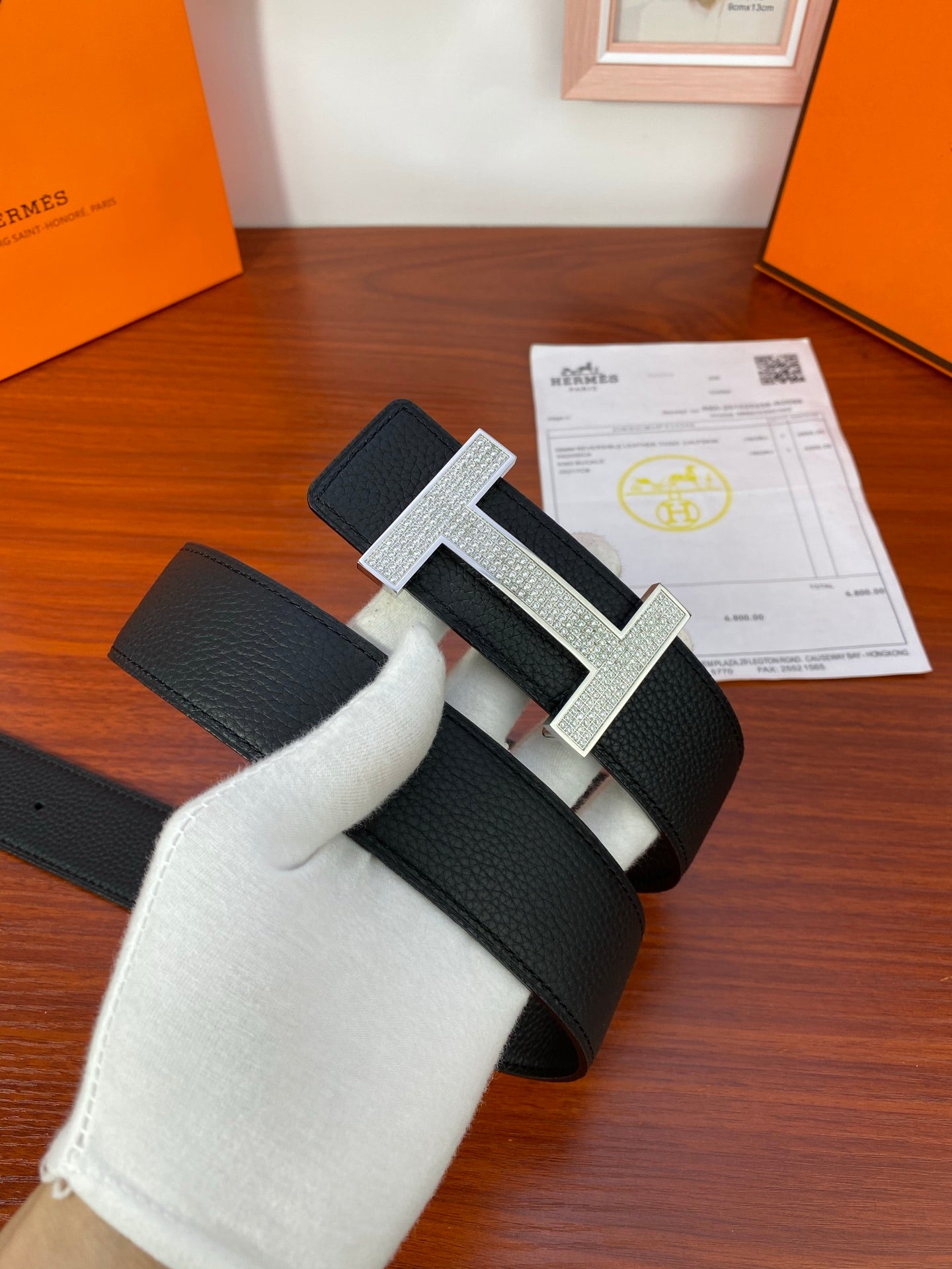 Hermes belt with black textured leather and silver-tone H buckle detail