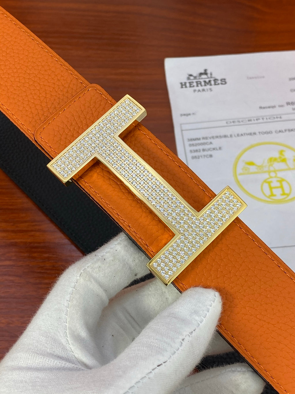 Leather belt strap with silver studded H buckle detail and orange panel