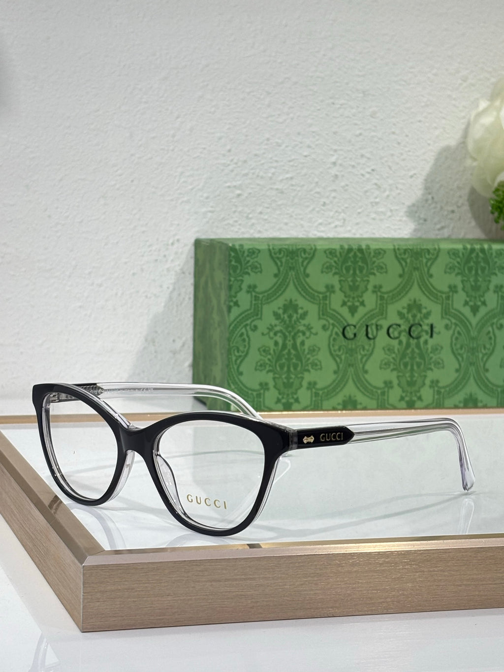 Gucci eyeglasses with black frames, clear lenses, and silver-toned temple tips