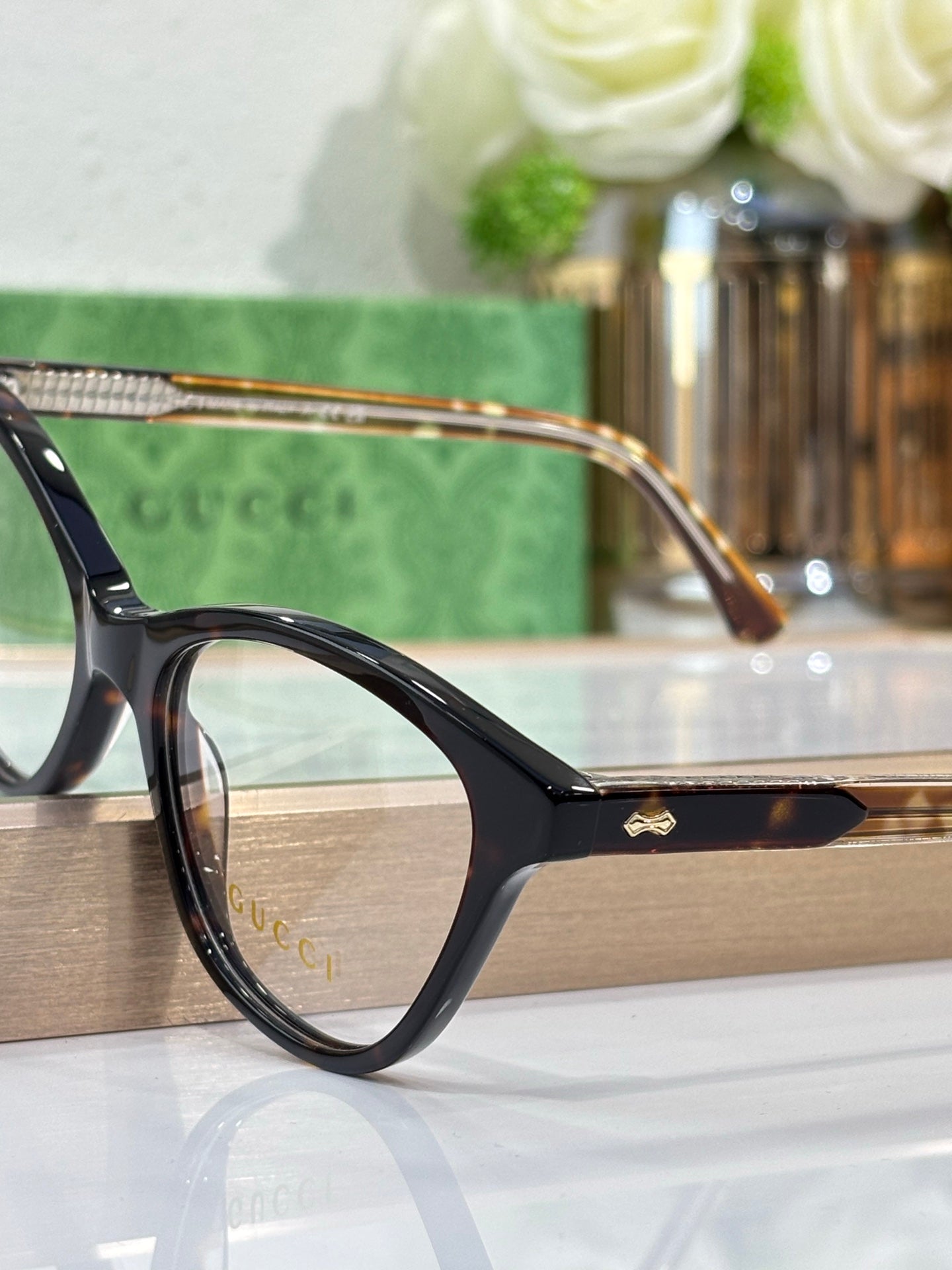 Gucci eyeglasses with black frames, gold bridge detail, and clear lenses