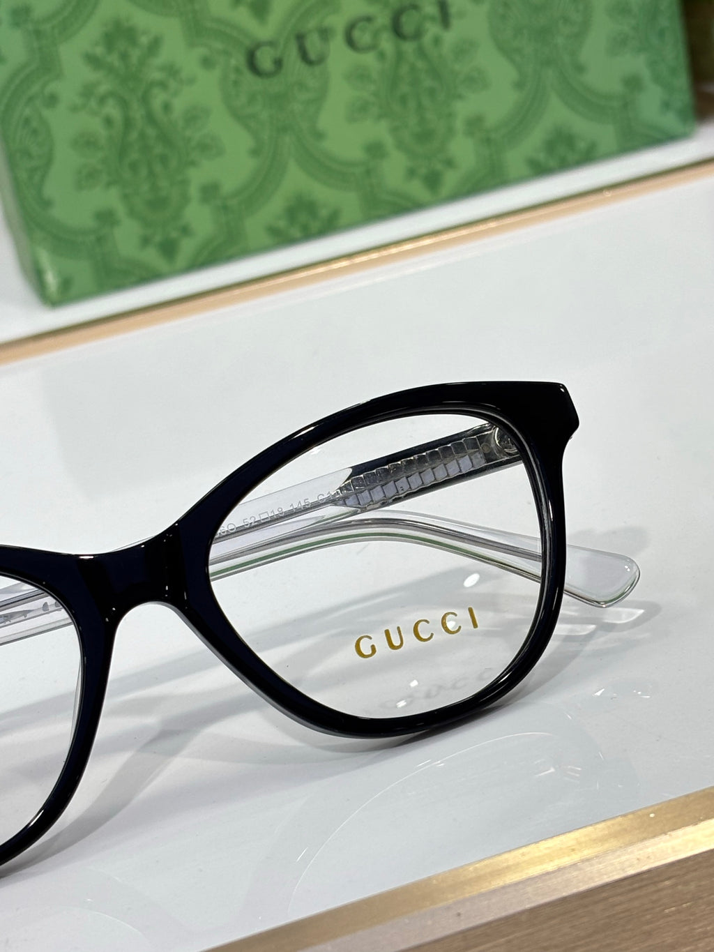 Gucci eyeglasses close-up of black round rectangular frame and clear lens