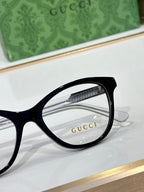Gucci eyeglasses close-up of black round rectangular frame and clear lens