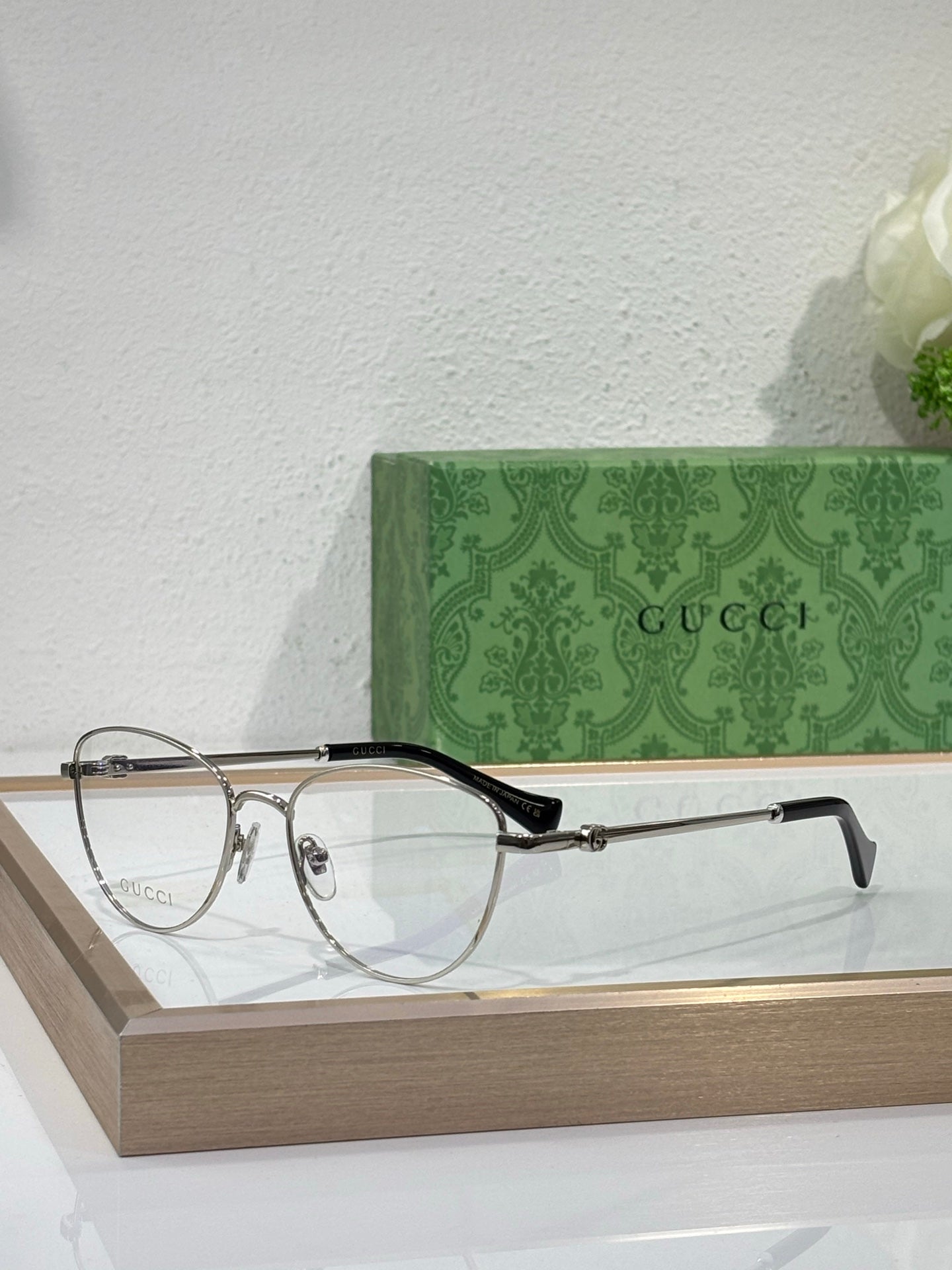 Gucci round eyeglasses with gold-tone frame and dark temples