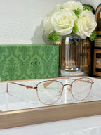 Gucci round eyeglasses with rose-gold frame and clear lenses