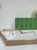 Gucci round eyeglasses with rose-gold metal frame and clear lenses