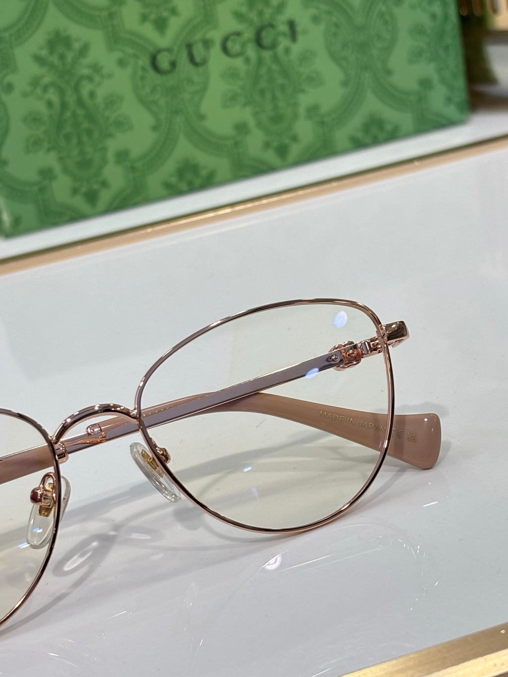 Gucci eyeglasses close-up: round clear lens with gold-tone bridge
