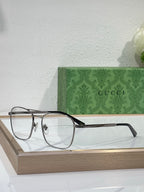 Gucci eyeglasses with clear lenses, dark temples and gold frame detailing