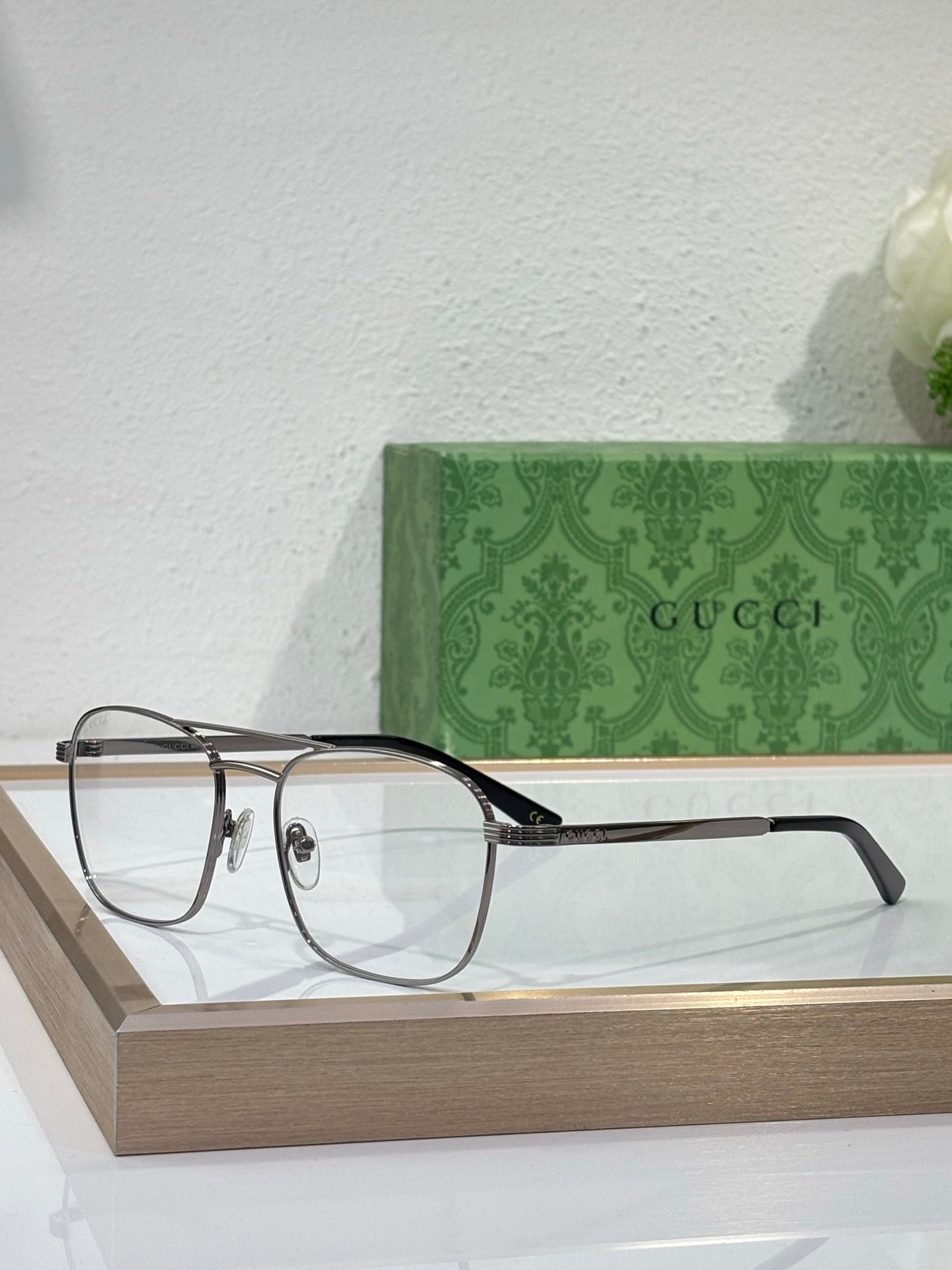 Gucci eyeglasses with clear lenses, dark temples and gold frame detailing
