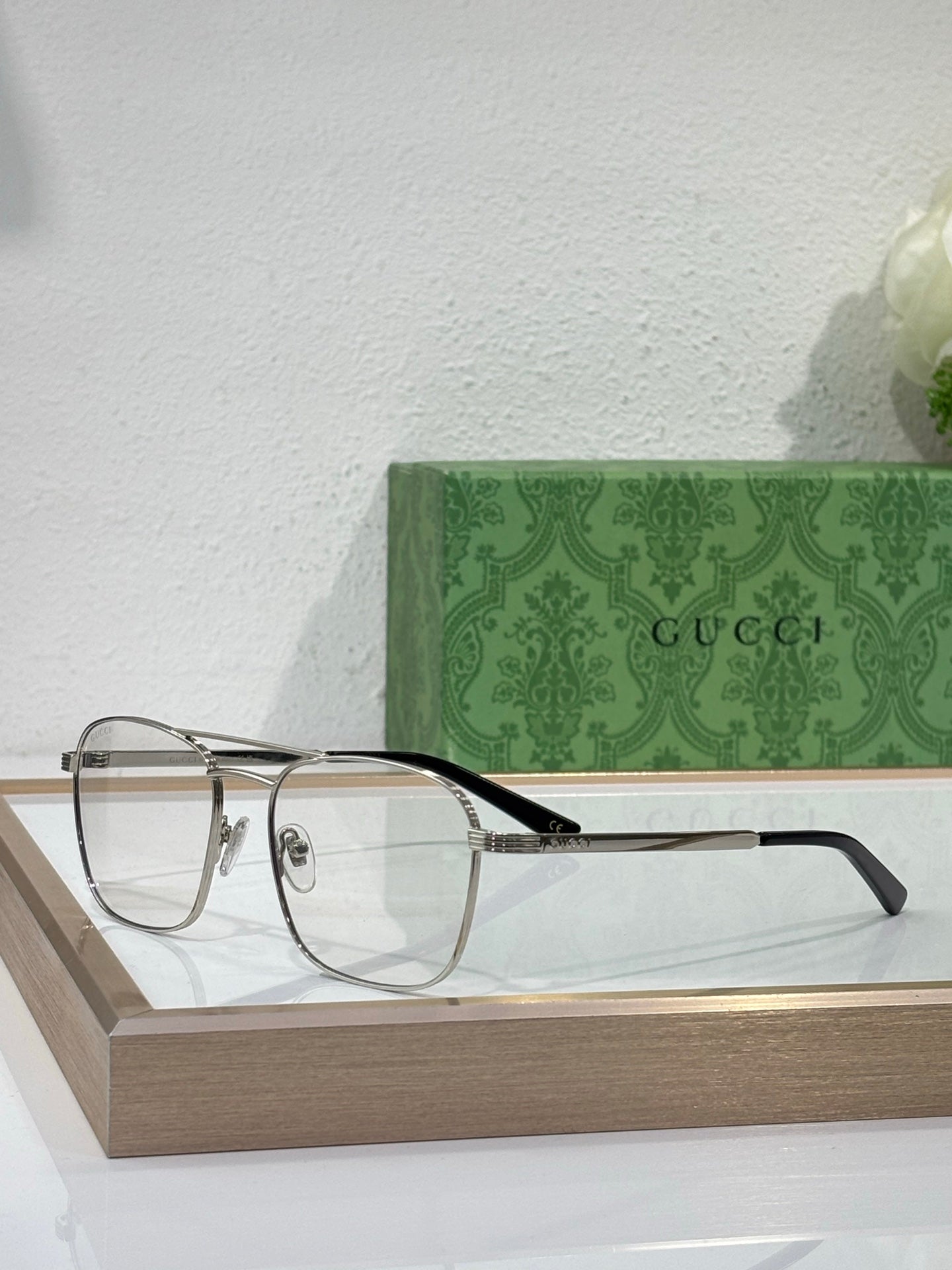 Gucci round eyeglass frames, clear lenses, gold temples and dark bridge