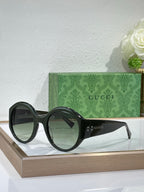 Black oversized round sunglasses with Gucci branding on the arms