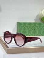 Burgundy round sunglasses with gradient lenses and Gucci logo on arms
