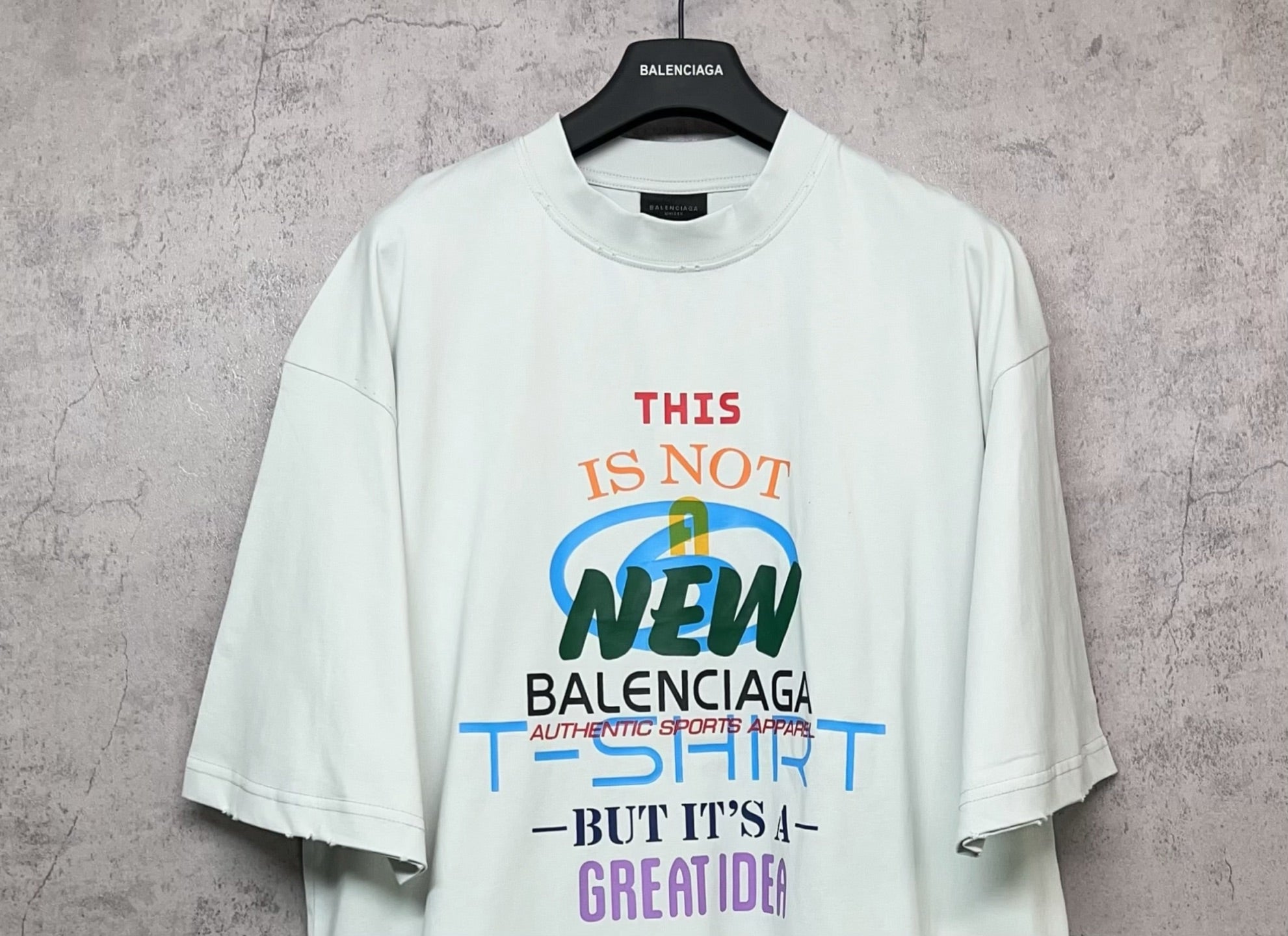 Balenciaga white T-shirt with front “THIS IS NOT NEW” and Balenciaga logo text