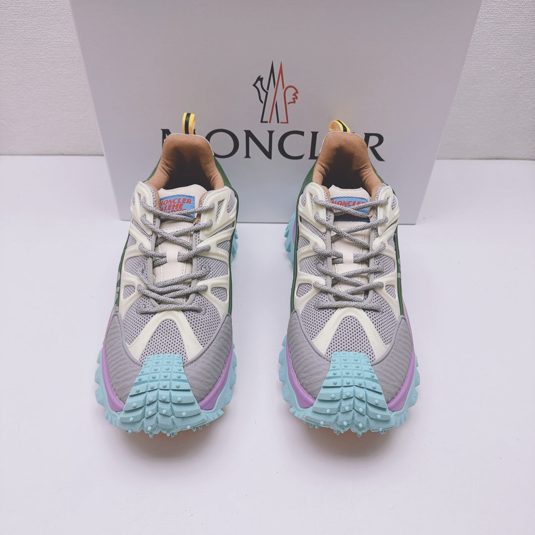 Moncler luxury sneakers, front view with white mesh upper and purple teal tread sole
