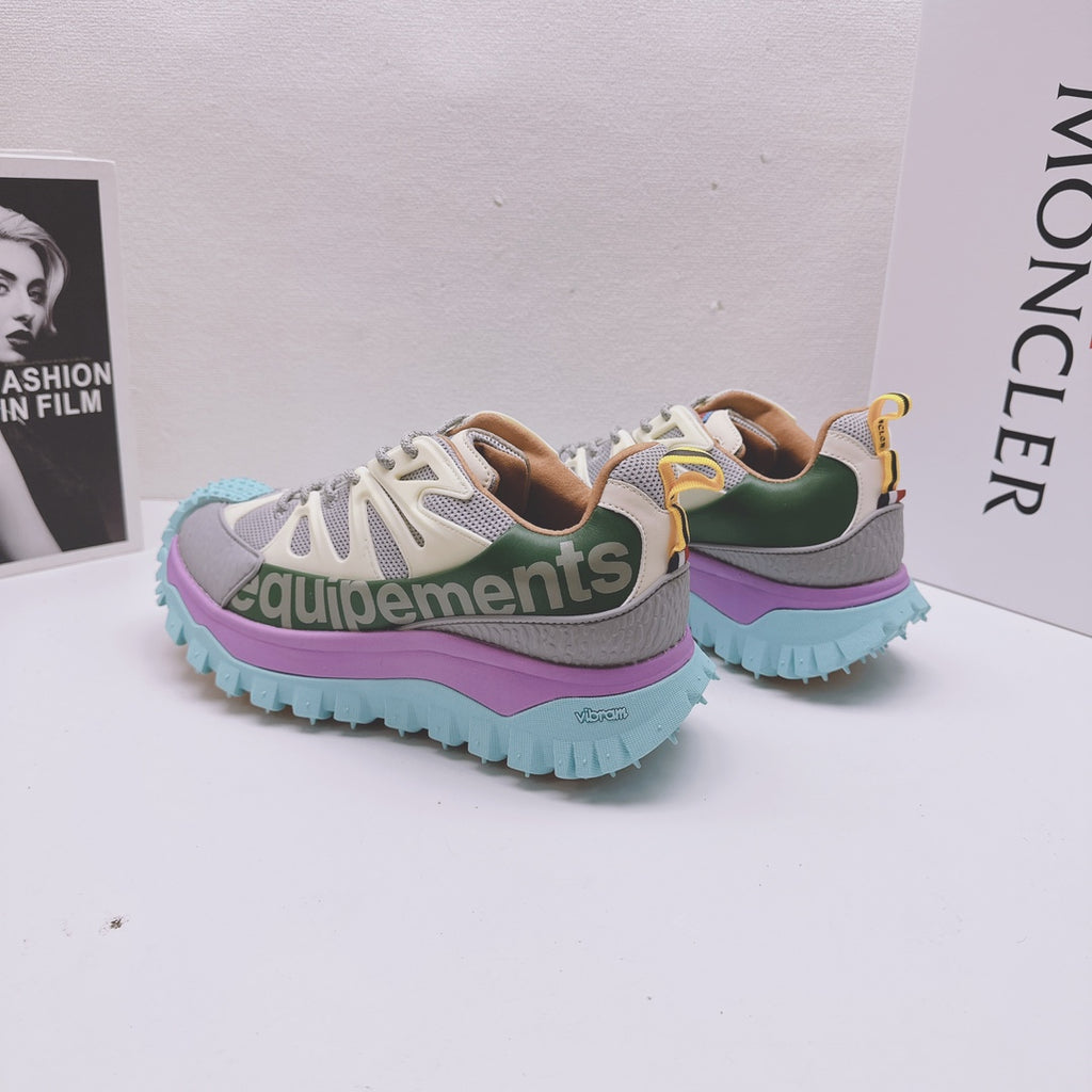 Moncler luxury sneakers pair, rear and side view with purple midsole and teal outsole