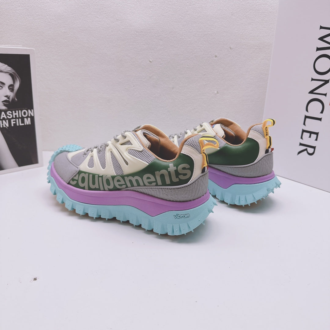 Moncler luxury sneakers pair, rear and side view with purple midsole and teal outsole
