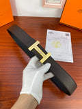 Hermes belt with black textured strap and gold-tone H buckle, with receipt card