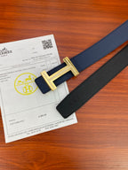Dark blue leather belt with gold buckle and engraved detail on the center frame.