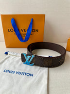 Louis Vuitton belt on white pouch, dark monogram with large blue LV buckle
