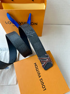 Louis Vuitton belt with LV buckle and dark textured strap end with prong