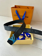 Louis Vuitton belt dark leather strap with blue LV buckle, laid across box contents.