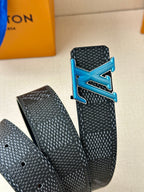 Louis Vuitton belt close-up of dark strap with blue LV buckle and punched adjustment holes.