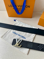 Dark textured belt laid flat with silver LV buckle and punched holes