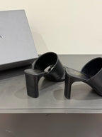 Black leather mule sandals with gold buckle, black block heel, pair on display