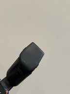 Black leather slide sandal, close-up of back heel and strap