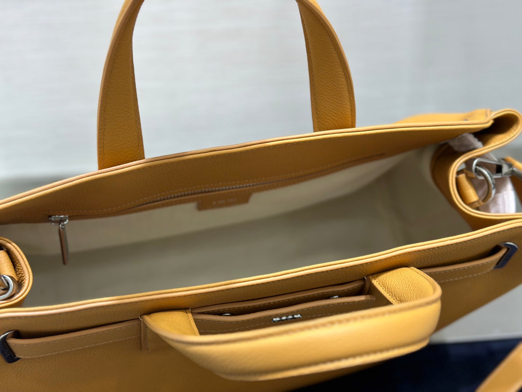 Inside view of tan leather tote with zip pocket and open top