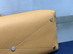 Tan leather side panel with small CD logo stud hardware