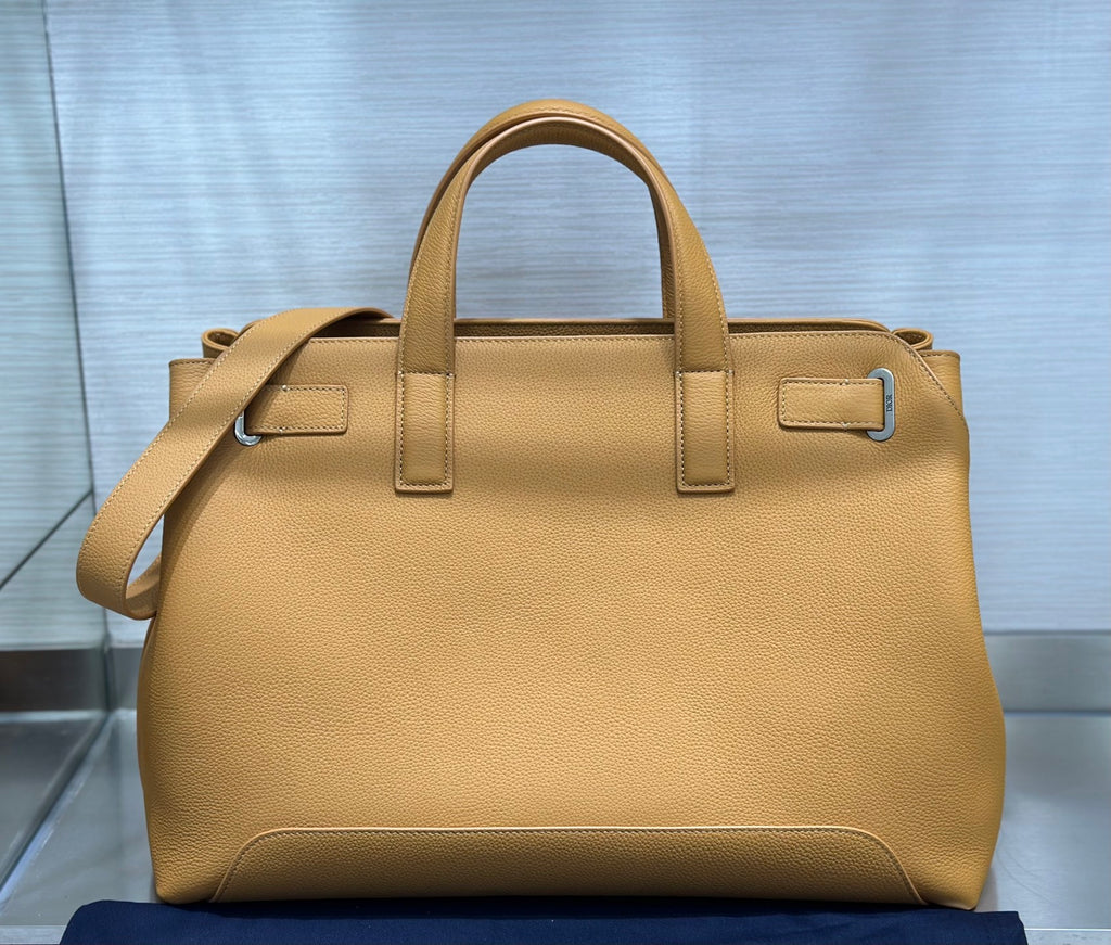 Tan leather Dior tote bag with top handles and side buckle fasteners