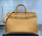 Tan leather Dior tote bag with top handles and side buckle fasteners