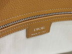 Dior Made in Italy label on tan leather with zipper trim close-up