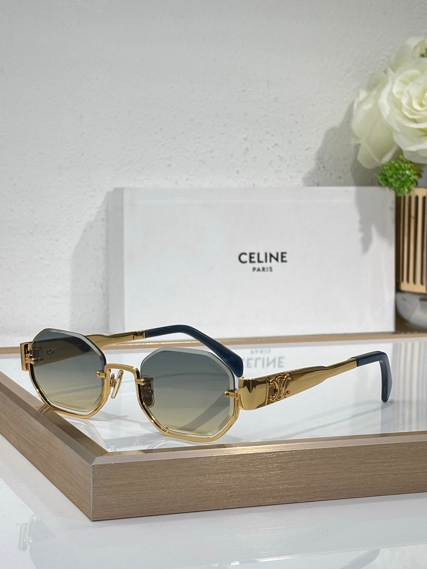 Celine sunglasses with gold-tone frames and blue-tinted lenses
