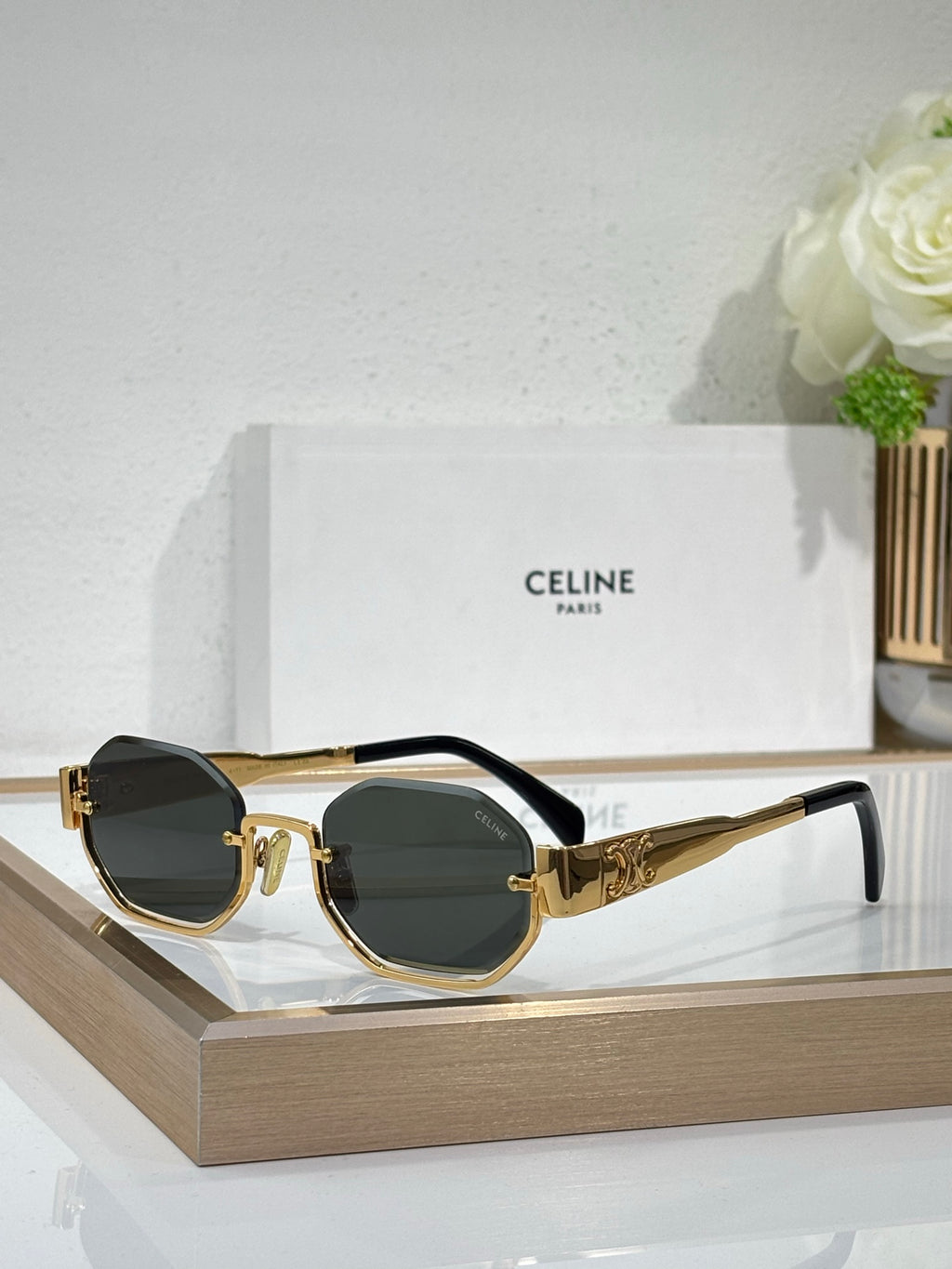Celine sunglasses with black and gold-tone frames and dark lenses