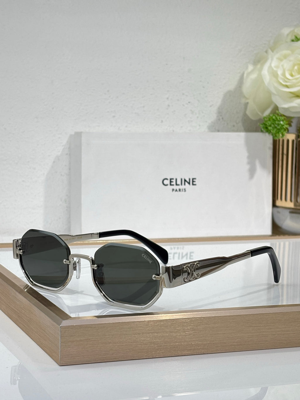 Celine sunglasses with black and silver frames and dark green-tinted lenses