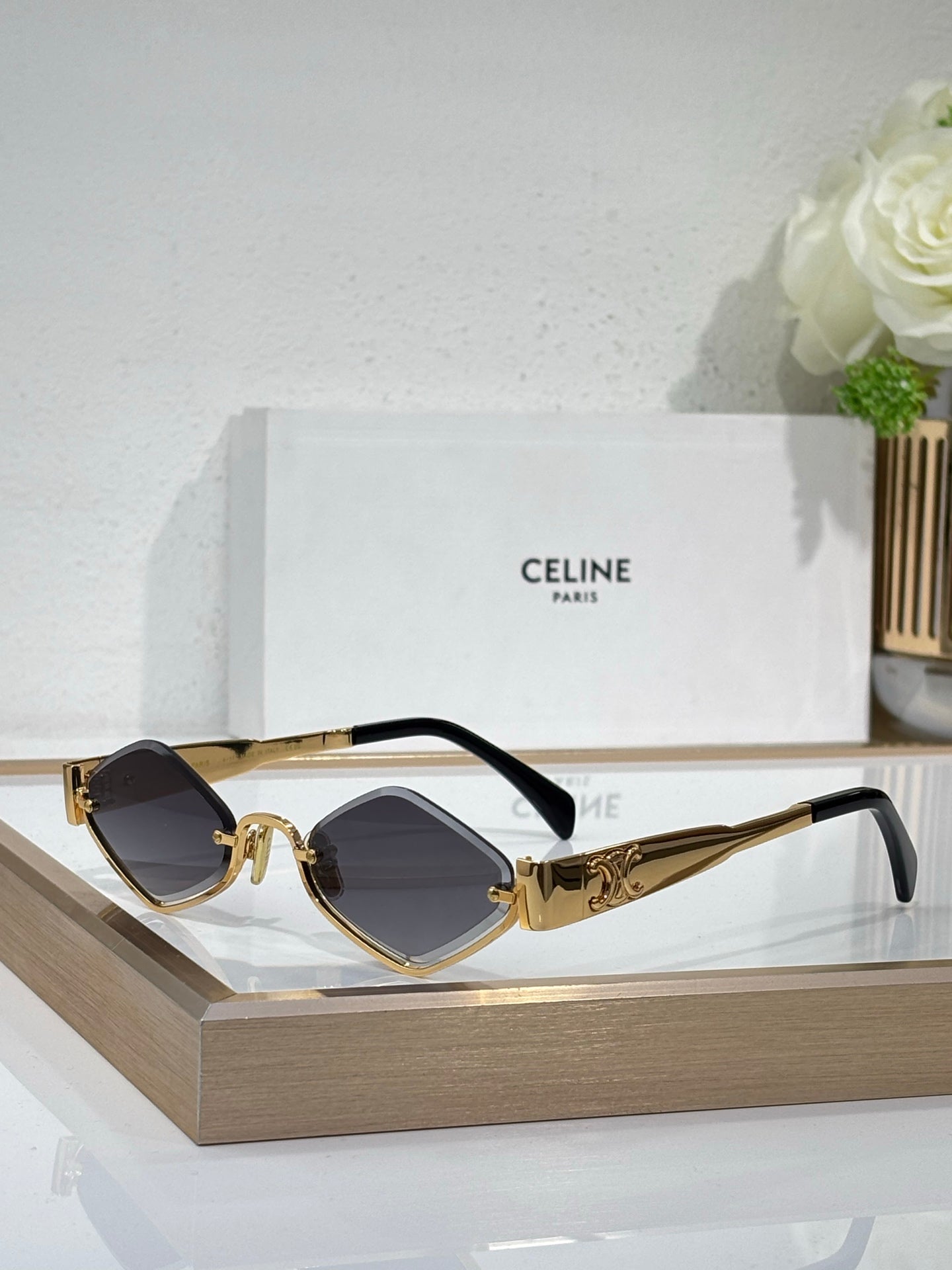 Celine eyeglasses with gold-tone frame, dark gray lenses and black temple arms.