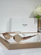 Celine eyeglasses with rose-tinted clear lenses, gold-tone metal frame, slim temples.