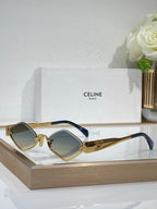 Celine eyeglasses with gold-tone frame, blue temple tips and dark green tinted lenses.