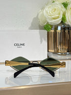 Celine eyeglasses with dark green lenses, gold frame and black temple arms.